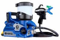 Blue Graco Ultra QuickShot II portable paint sprayer with hose and pistol grip spray gun attached to a paint reservoir at right side.