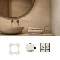 EdPlit RAMKA DO GNIAZDKA TRÓJBIEGUNOWEGO I WYŁĄCZNIKA (E40011) Bathroom vanity with round mirror, wall-mounted faucet, folded towels, and a square wall switch area near the sink (informational image).