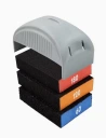 Stack of four color-coded notebooks or boxes with gray curved lids and black bodies, arranged in a tower.